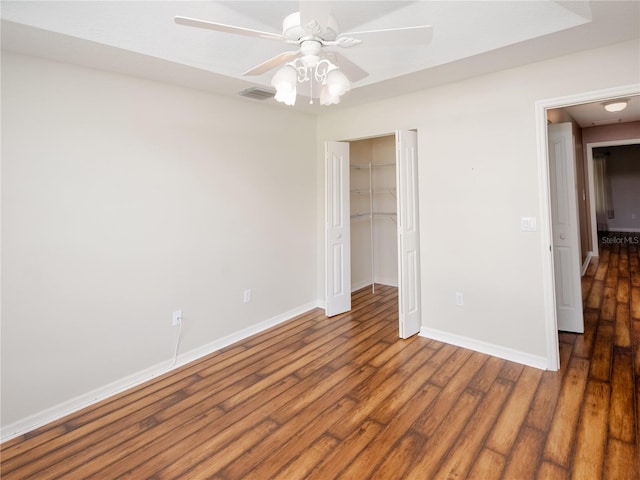 unfurnished bedroom with a closet, ceiling fan, and hardwood / wood-style floors