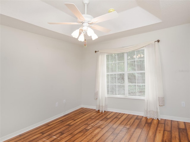 spare room featuring hardwood / wood-style floors and ceiling fan