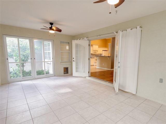 empty room featuring ceiling fan and light hardwood / wood-style flooring