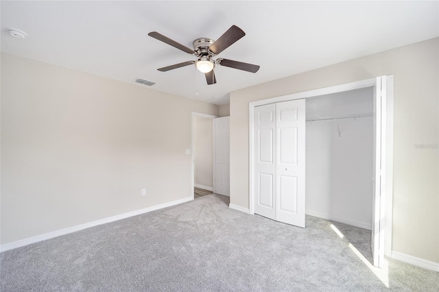 unfurnished bedroom with ceiling fan, a closet, and light colored carpet