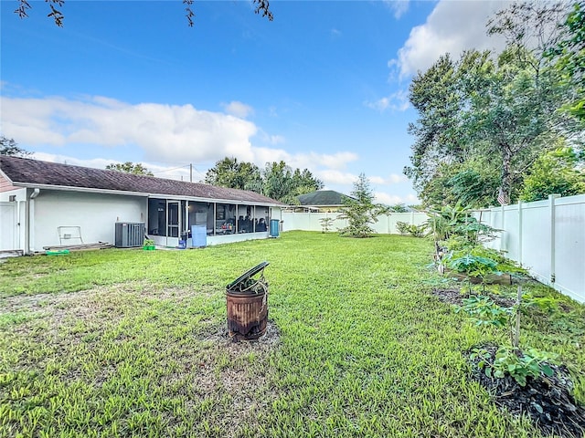 view of yard featuring a sunroom and central AC