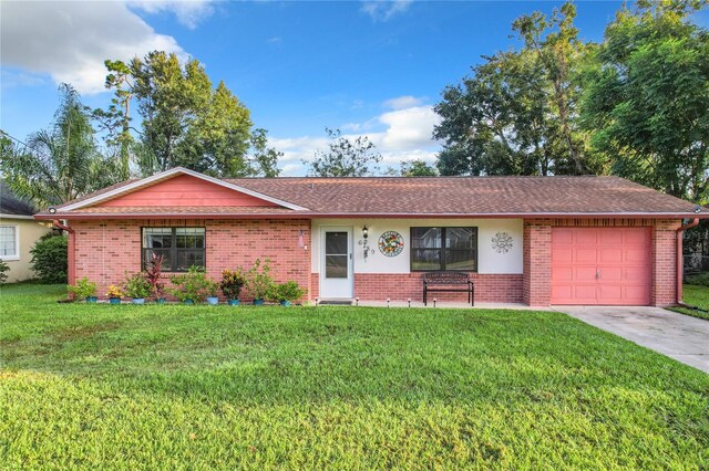 ranch-style home with a front yard and a garage