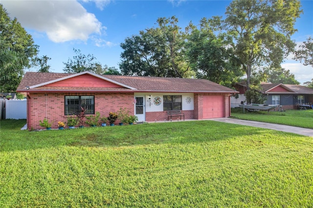 ranch-style house with a garage and a front lawn