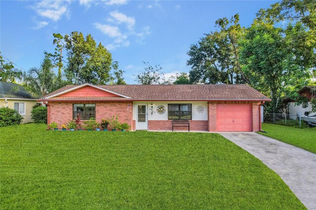 single story home featuring a garage and a front lawn