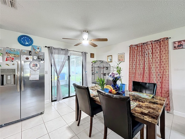 dining room featuring ceiling fan, a textured ceiling, and light tile patterned floors