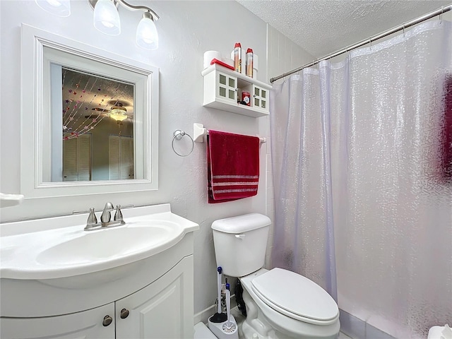 full bathroom with curtained shower, a textured ceiling, toilet, and vanity
