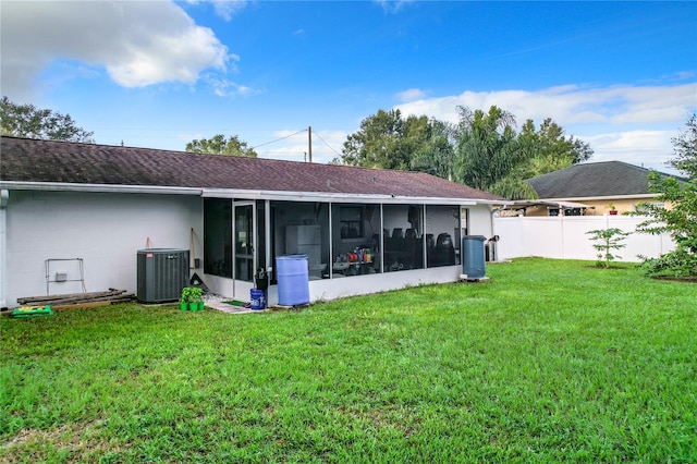 back of house with a lawn, central AC, and a sunroom