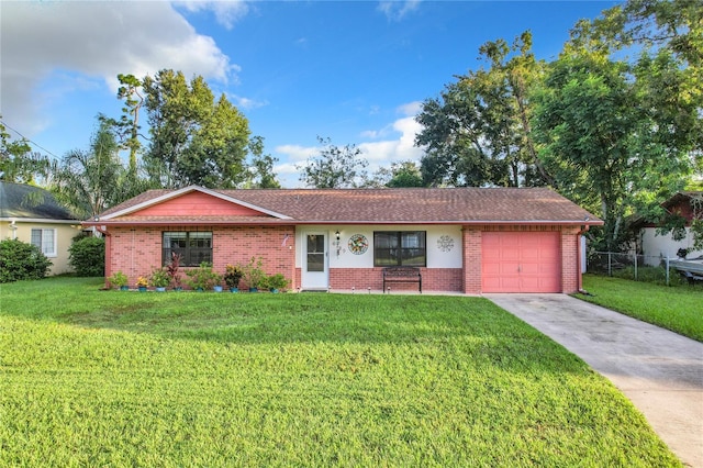 ranch-style home featuring a front yard, brick siding, concrete driveway, and an attached garage
