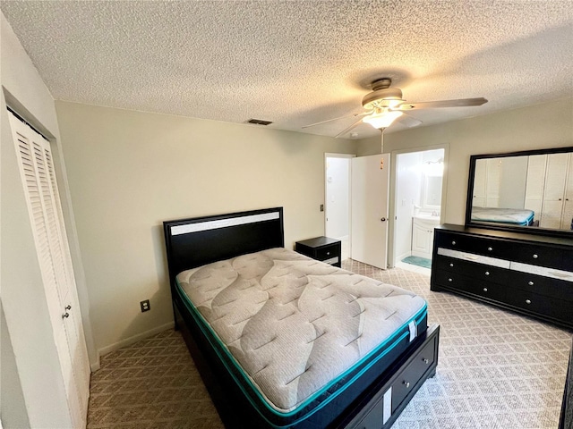 6789 SE 54th Ln, Ocala, FL 34472 - bedroom with carpet flooring, a textured ceiling, a closet, a ceiling fan, and ensuite bath