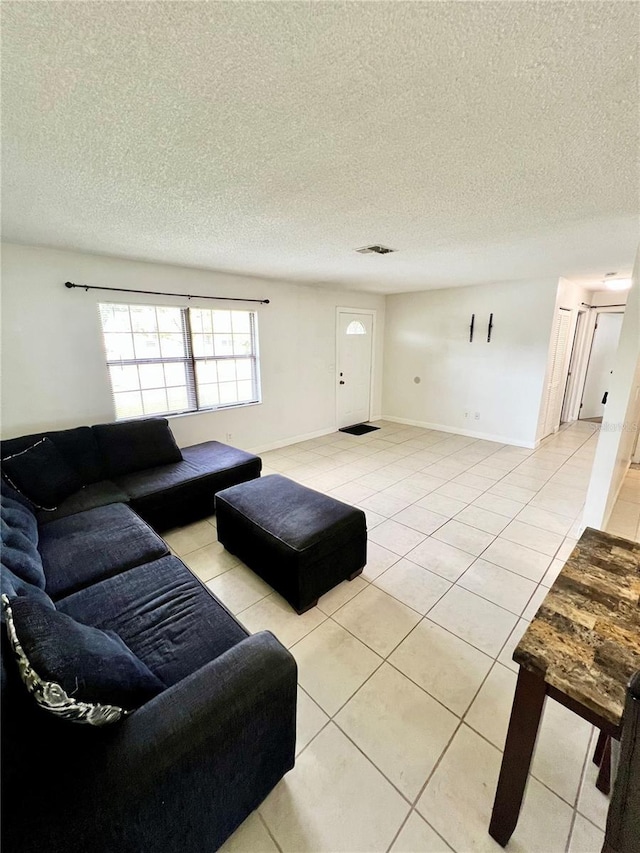 6789 SE 54th Ln, Ocala, FL 34472 - living area with light tile patterned floors and a textured ceiling