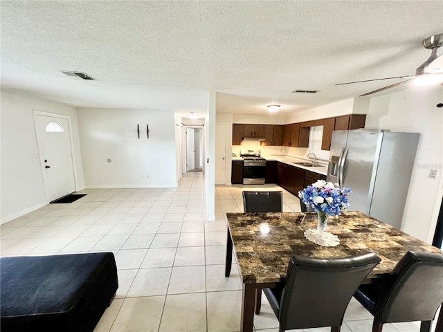 6789 SE 54th Ln, Ocala, FL 34472 - dining room with light tile patterned flooring, a textured ceiling, and ceiling fan