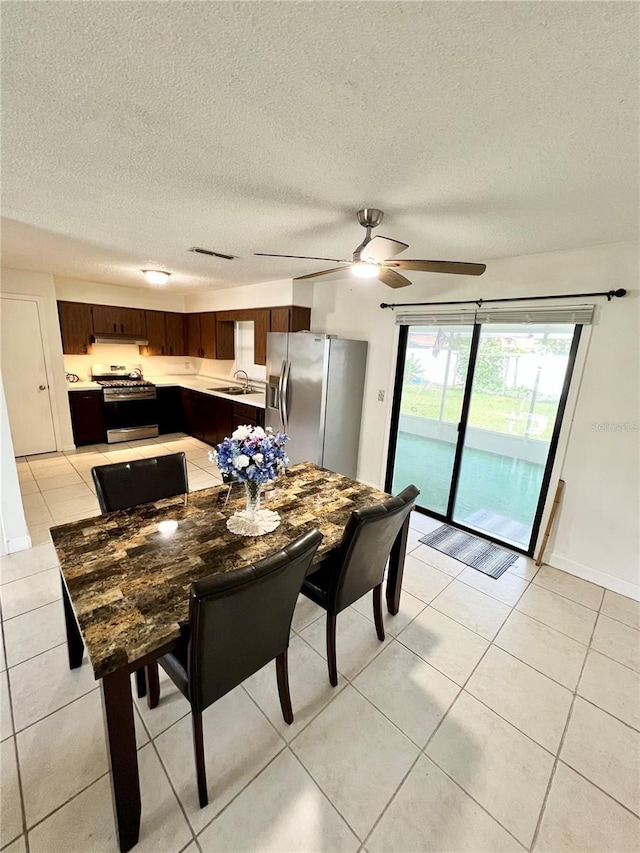 6789 SE 54th Ln, Ocala, FL 34472 - dining area with light tile patterned floors, ceiling fan, and a textured ceiling