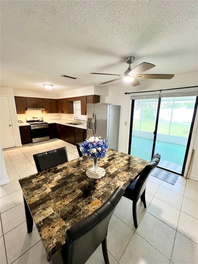 6789 SE 54th Ln, Ocala, FL 34472 - dining room with light tile patterned flooring, a textured ceiling, and ceiling fan