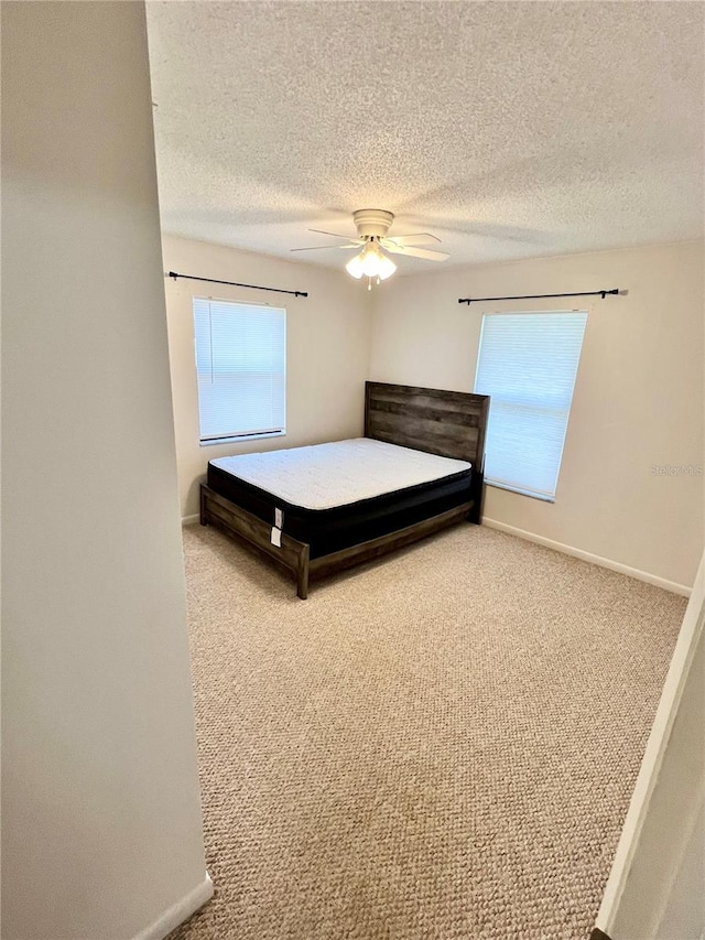6789 SE 54th Ln, Ocala, FL 34472 - bedroom with carpet flooring, a textured ceiling, and ceiling fan