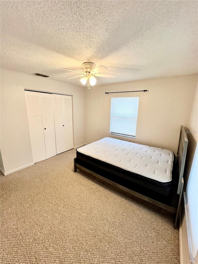 6789 SE 54th Ln, Ocala, FL 34472 - carpeted bedroom featuring a closet, a ceiling fan, and a textured ceiling