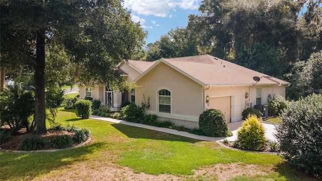 ranch-style house with central AC unit, a front yard, and a garage