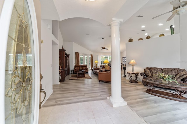 foyer entrance with ceiling fan, light wood-type flooring, decorative columns, and lofted ceiling