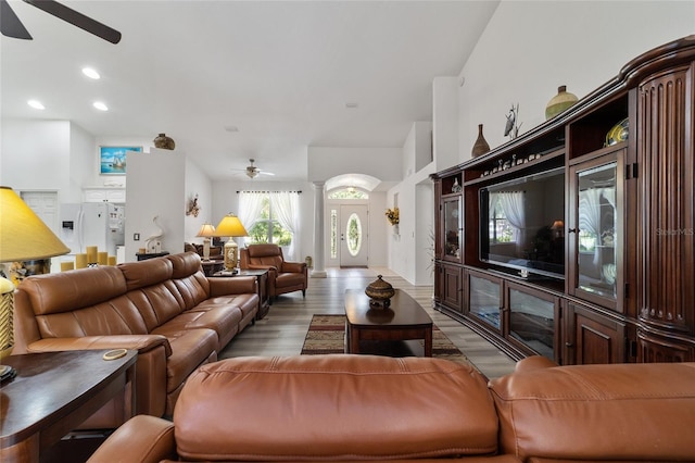 living room with ceiling fan and light wood-type flooring