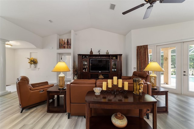 living room featuring light hardwood / wood-style floors, vaulted ceiling, ceiling fan, and french doors