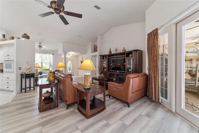 living room with ceiling fan, lofted ceiling, and light hardwood / wood-style flooring