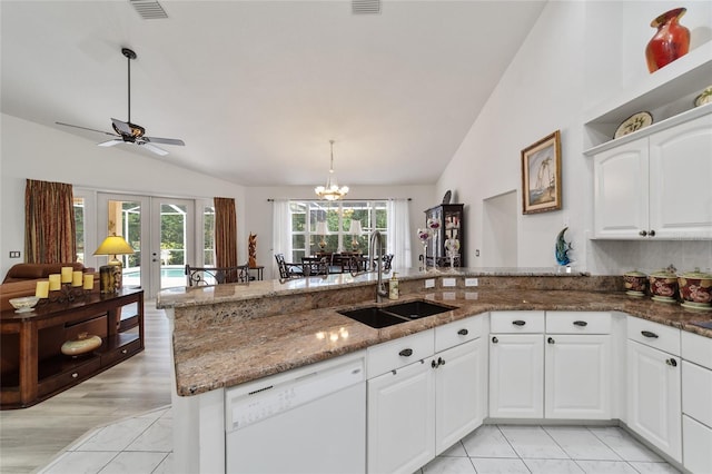 kitchen featuring ceiling fan with notable chandelier, vaulted ceiling, dishwasher, and sink