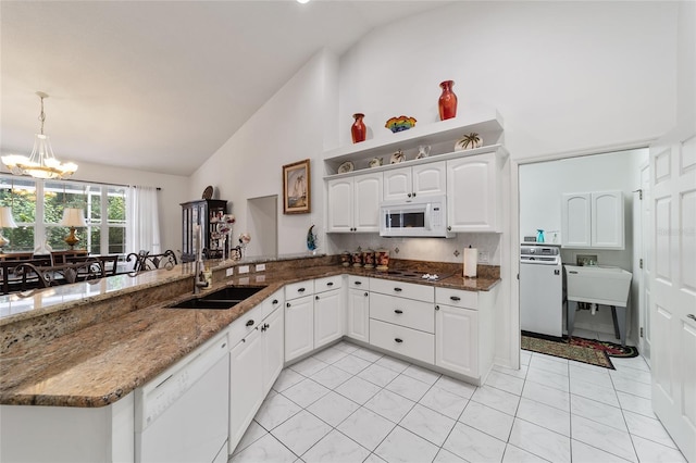 kitchen featuring white cabinetry, white appliances, decorative light fixtures, sink, and a notable chandelier