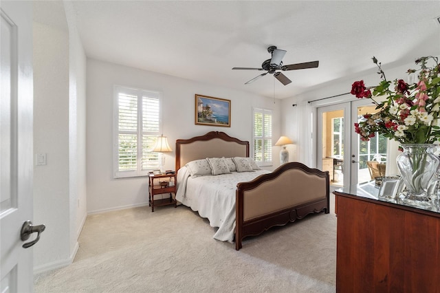 carpeted bedroom featuring access to outside, ceiling fan, and french doors