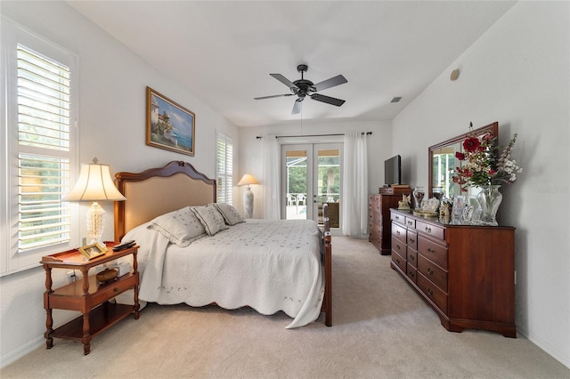 bedroom with multiple windows, access to outside, ceiling fan, and light colored carpet