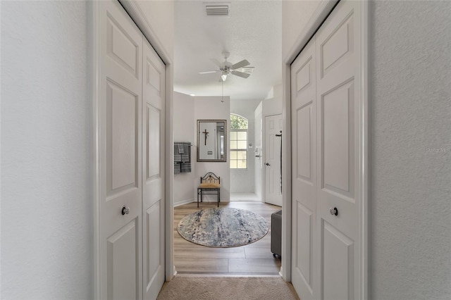 hallway with light hardwood / wood-style flooring