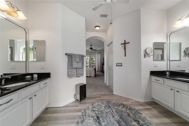 bathroom with hardwood / wood-style floors, ceiling fan, and vanity