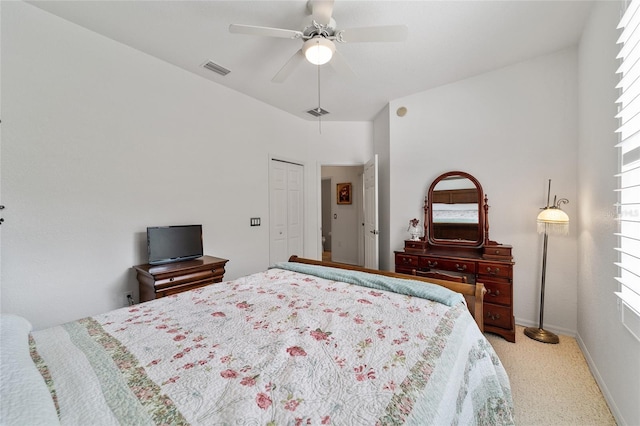 carpeted bedroom with ceiling fan and a closet