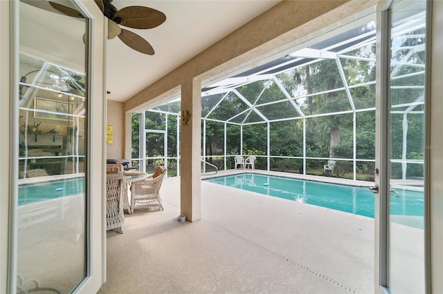 view of swimming pool with a patio, a lanai, and ceiling fan