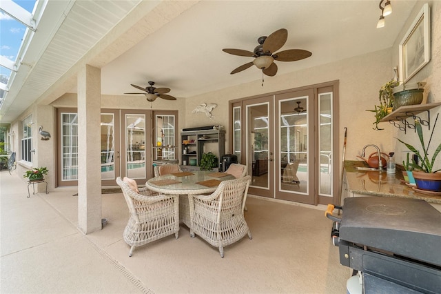 view of patio with ceiling fan and french doors