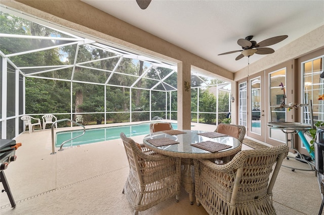 view of pool featuring a lanai, ceiling fan, a patio area, and french doors