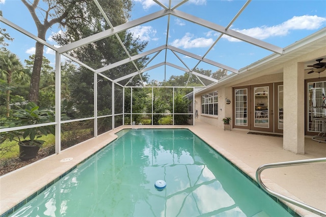 view of pool with a lanai, ceiling fan, and a patio area