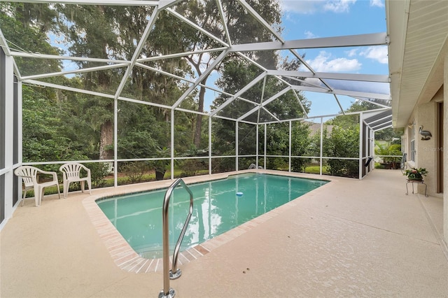 view of pool with a patio and glass enclosure