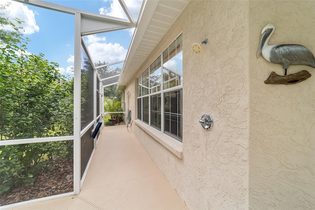 unfurnished sunroom with a skylight