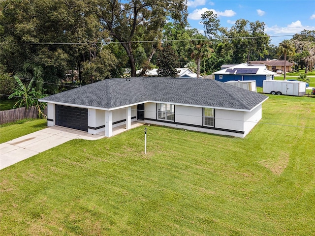 view of front of house with a garage and a front lawn