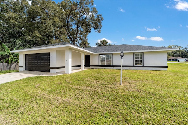 single story home featuring a garage and a front lawn