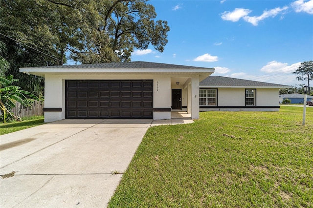 view of front of house with a front yard and a garage