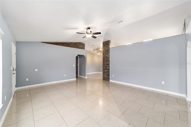 unfurnished room featuring ceiling fan, light tile patterned floors, and vaulted ceiling