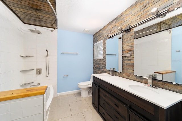 bathroom with tile patterned floors, vanity, tile walls, and toilet