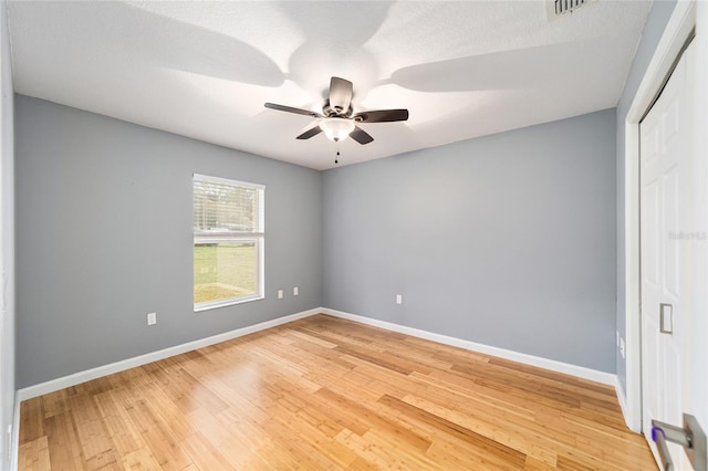 empty room featuring hardwood / wood-style floors, ceiling fan, and a textured ceiling