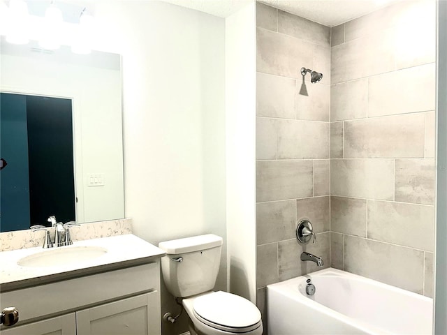 full bathroom featuring a textured ceiling, tiled shower / bath combo, vanity, and toilet