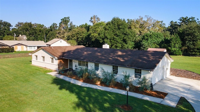 single story home with a front yard and a garage