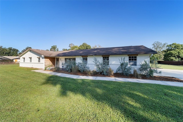 ranch-style home with a front lawn