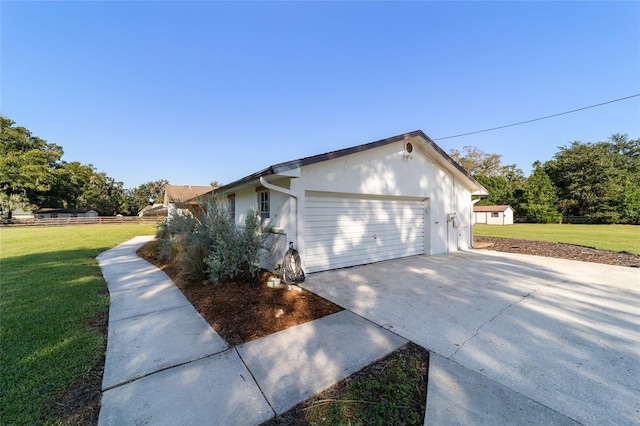 view of home's exterior with a lawn and a garage