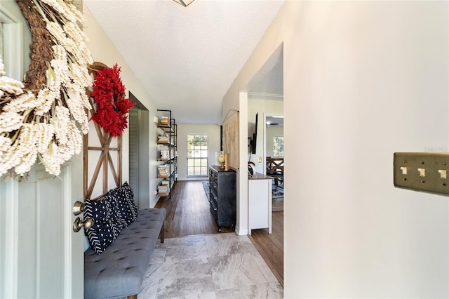 corridor featuring a textured ceiling and hardwood / wood-style flooring