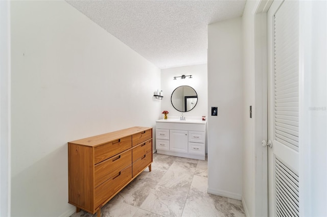 bathroom featuring vanity and a textured ceiling