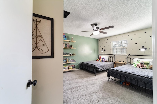 carpeted bedroom featuring a textured ceiling and ceiling fan